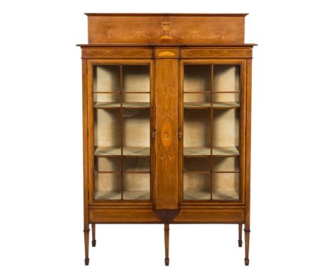 An Edwardian mahogany and inlaid display cabinet: crossbanded in satinwood, bordered with boxwood and ebony lines, the ledge 