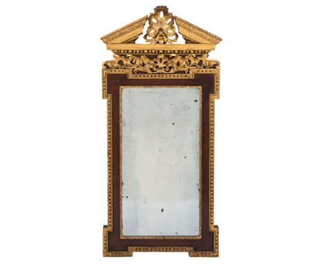 A 19th Century walnut and parcel-gilt architectural wall mirror:, in the George II taste, the acanthus decorated broken pedim