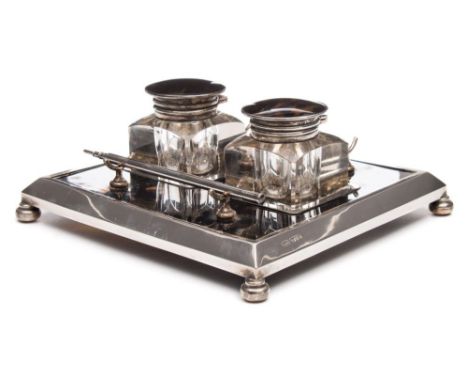 A George V tortoiseshell and silver mounted inkwell stand, maker Grey & Co, Chester, 1912: of square outline, with two clear 