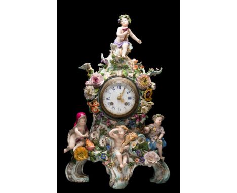 A Meissen porcelain mantel clock: in the form of four allegorical putti representing the four seasons amongst elaborate appli