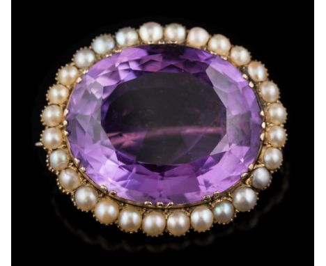 An amethyst and seed pearl oval brooch: with central oval amethyst, 24mm long within a surround of seed-pearls.