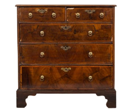 An early 18th Century walnut and oak diagonally crossbanded chest:, the quarter veneered top with a moulded edge, containing 