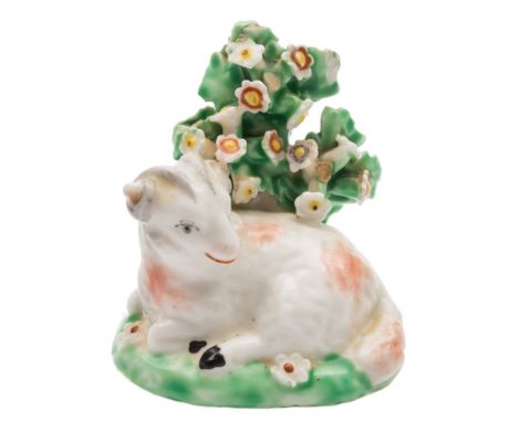 A Derby model of a recumbent ram: on mound base with bocage background, circa 1765-70, 6 cm high [minor chips to bocage].