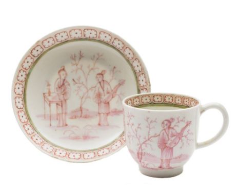 A Lowestoft coffee cup and saucer: painted in pink monochrome with two Chinese figures in a garden, one playing a stringed in