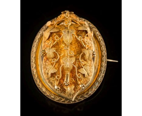 A mid-Victorian gold oval brooch locket: with a hinged front panel of textured foliate filigree design, opening to reveal a g