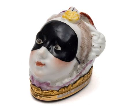 A Chelsea bonbonniere: in the form of a lady's head, wearing a black mask, inset rose diamond eyes and pink trimmed bonnet wi