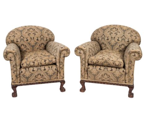 A pair of 1920's carved mahogany armchairs:, fully upholstered with curved arched backs and cushion seats with gadrooned seat