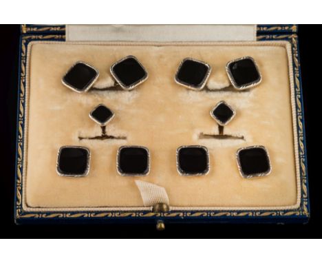 A suite of platinum-faced 14ct gold and black onyx panel cuff-links, buttons and studs: 16gms gross weight, in fitted case.