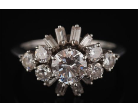 Boucheron. A diamond cocktail cluster ring: the central circular, brilliant-cut diamond approximately 0.90ct, within a surrou