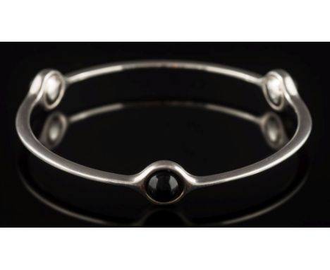 Georg Jensen. A sterling silver sphere bangle: designed by Regitze Overgaard for Georg Jensen, the bangle set with three cabo