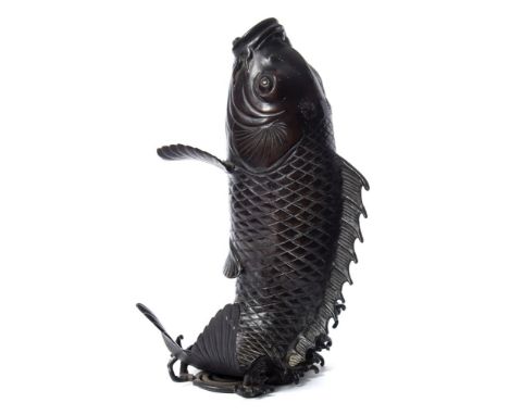 A Japanese bronze model of a leaping carp: with open mouth. and wide apart fins, unsigned, 29cm. high.