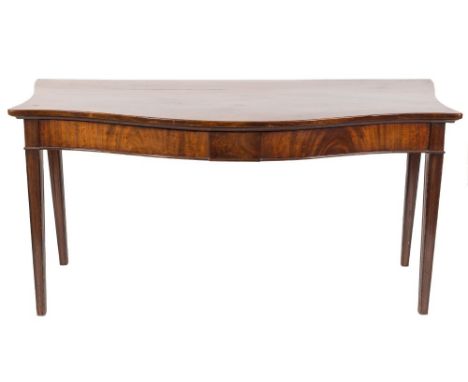 An early 19th Century mahogany serpentine fronted serving table:, with serpentine sides, the apron with plain rectangular cen