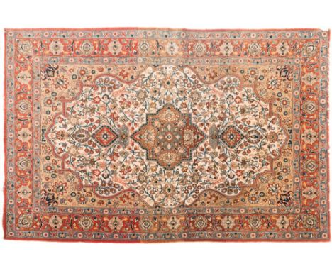 A Qum rug:, the ivory cartouche field with a central light brown flowerhead pole medallion, all over scrolling palmette and f