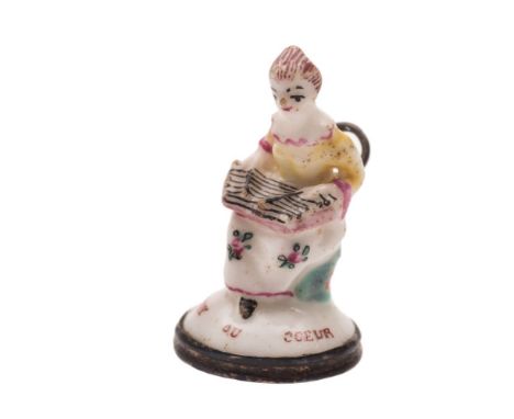 A St. James's [Charles Gouyn] 'toy' seal: in the form of a seated lady playing a zither and wearing a yellow jacket and flora