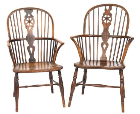 An early 19th Century elm, ash and beechwood wheel and stick back Windsor elbow chair:, having a shaped solid seat, on turned