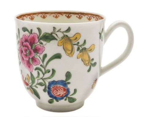 A First Period Worcester coffee cup: painted in bright famille rose colours with a large peony and other flowers interspersed