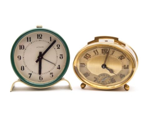 A Jaeger-LeCoultre boudoir clock: the eight-day duration timepiece movement with alarm, the round cream dial having Arabic ho