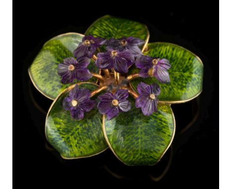 A green enamelled and carved amethyst 'violet' spray brooch: with carved amethyst 'violet' flower heads and green enamelled l
