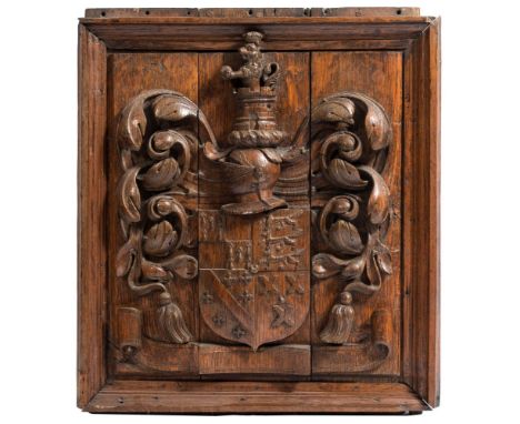 A carved oak coat of arms plaque: the quartered shield surmounted by a knight's helmet, turret and castle flanked by foliage 