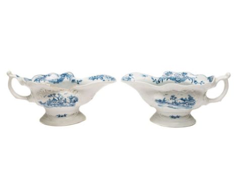 A pair of First Period Worcester blue and white high-footed sauceboats: each of silver shape with scroll handle, painted with