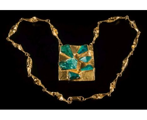 A mottled green hardstone mounted panel pendant: the freeform rectangular panel 63mm x 52mm suspended on a necklace of free-f