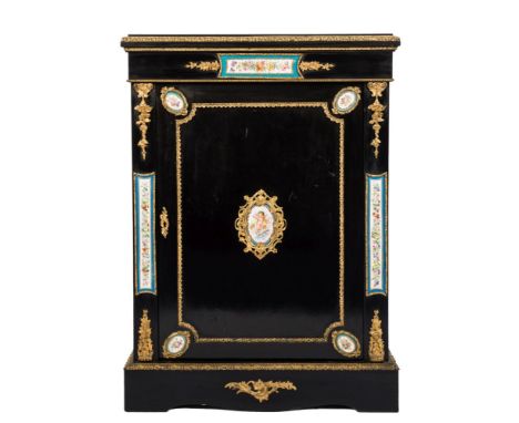 A 19th Century French ebonised and gilt metal and porcelain mounted pier cabinet:, applied with Sevres style porcelain panels