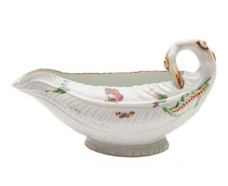 A First Period Worcester cos lettuce sauceboat: with curled stalk handle and overlapping leaves, painted with butterflies, fl