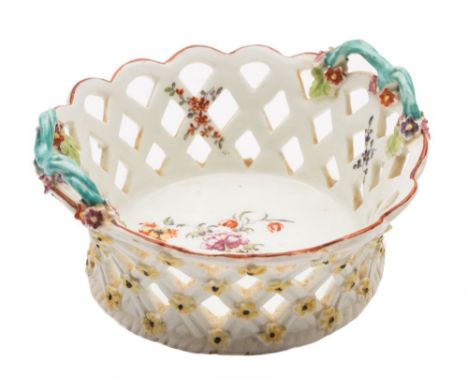 A Derby two-handled basket: of small size, the pierced trellis sides applied with yellow florets to the exterior, the interio
