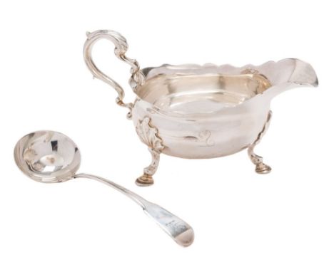A Georgian silver sauce boat, all marks worn: of traditional design with wavy-edge border, acanthus capped scroll handle, rai