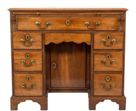 A George III mahogany kneehole desk:, the rectangular top with a moulded edge, fitted with a slide, a single long frieze draw