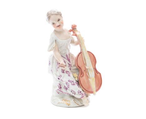 A Meissen porcelain figure of a lady musician: seated playing a cello, her skirt painted with floral sprays in puce monochrom