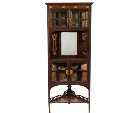 An Art Nouveau mahogany and inlaid standing corner display cabinet:, with a moulded cornice and frieze with copper cartouche 