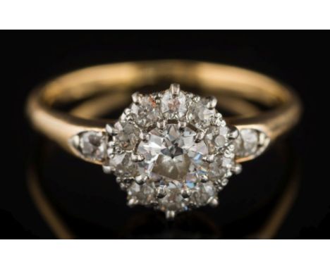 A Victorian gold and diamond, circular cluster ring: the central old brilliant-cut diamond within a surround of smaller, old-