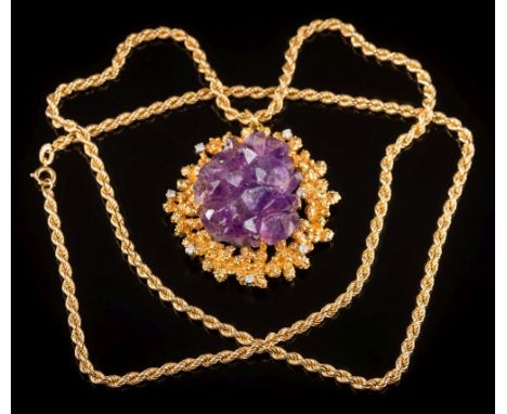 An amethyst matrix crystal and diamond-set pendant: the central, four-claw-set amethyst within a textured surround, inset wit