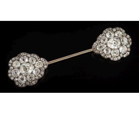 A diamond mounted jabot pin: with two pear-shaped clusters, each pave-set with a central pear-shaped diamond approximately 1.