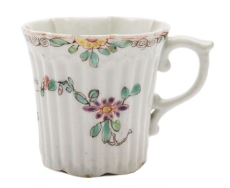 An early Worcester ribbed coffee can: of lobed form with pleated rim and scroll handle, painted with trailing flowers and fol