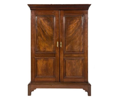 A mid 18th Century mahogany side cupboard on a low stand:, adapted as a wardrobe with a moulded dentil cornice and cushion fr