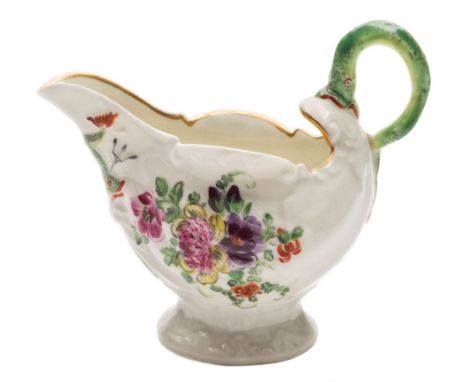 A First Period Worcester dolphin ewer creamboat: with green lamprey handle, painted with floral sprays and sprigs, two crosse