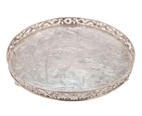 A Chinese silver circular tray, maker Wang Hing & Co , Hong Kong: the centre decorated with cranes amongst bamboo shoots and 
