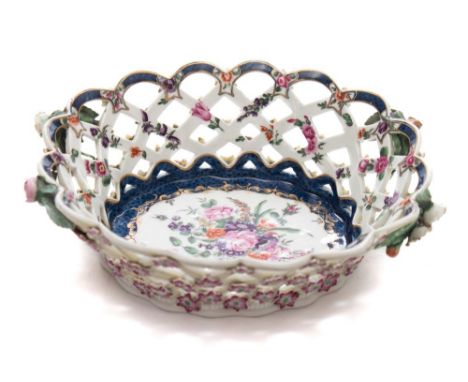 A First Period Worcester basket: of oval form with pierced lattice sides, painted with floral sprays and sprigs within gilded
