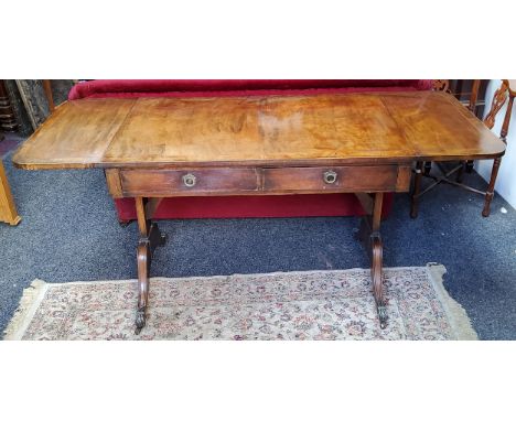 A Regency style sofa table, two short drawers to frieze,&nbsp;brass lion paw feet 