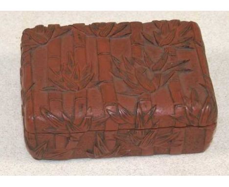 A late 19th century Chinese cinnabar lacquered rounded rectangular box and cover, decorated throughout with bamboo, width 12c