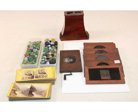 A quantity of predominantly early 20th century glass marbles, also a stereoscope and cards.Condition Report: Some discolourat