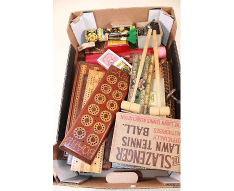 A group of collectors' items, all with a gaming theme, including cribbage boards, circular bone tokens, a kaleidoscope, vinta