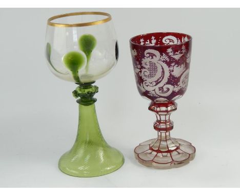 A 19thC Austrian ruby flash goblet, engraved with foliate scrolls, architectural features and running deer, on a double knopp