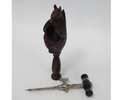 A carved treen nut cracker, in the form of a squirrel and a No 3 champagne or soda water tap in original box, (2)
