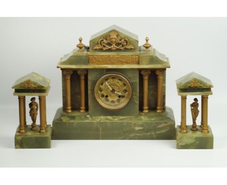 An early 20thC green onyx clock garniture, of architectural form having Corinthian column supports, 34cm high.