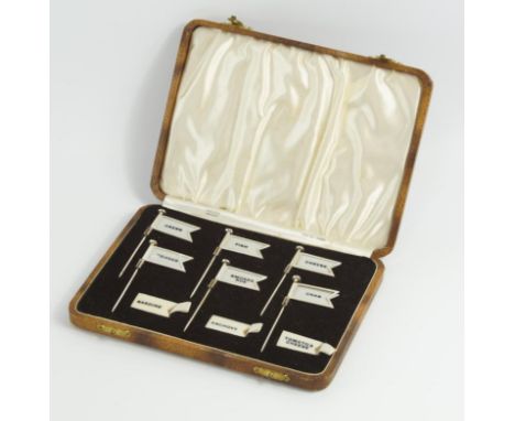 A set of six Sterling silver sandwich markers, in the form of flags with a variety of imitation ivory name tags, in a fitted 