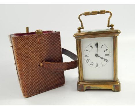 A French brass carriage clock, with white enamel dial and Roman numerals, 15cm high (handle up), with key and in original lea