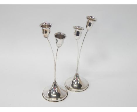 A pair of modern Sterling silver candleholders, each with two holders on slender stalk stems, circular bases, 20cm high